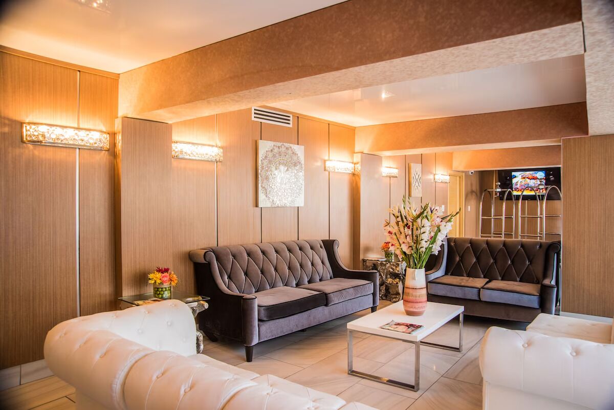 A modern living room with two sofas, a coffee table, and decorative lighting.
