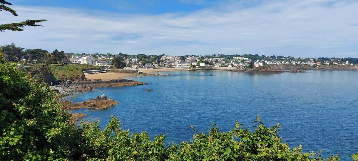 A coastal town with a sandy beach and calm waters.