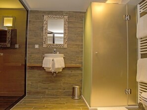 A modern bathroom with a wooden vanity, a sink with a mirror, and a shower area. - Les Chambres de Louise (Habsheim)