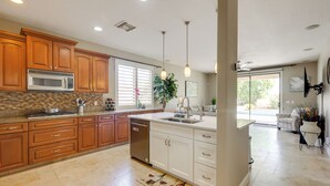 A kitchen with wooden cabinets, a microwave, and a dishwasher. - Private Yard & Fairway View: Phoenix Golf Retreat! (Phoenix)