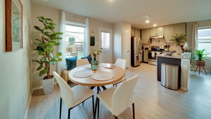 A modern kitchen with a central island, white cabinetry, and stainless steel appliances. - Easy Access to Dtwn San Antonio: Suburban Home (San Antonio)