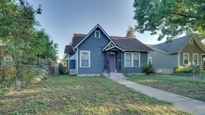 A two-story house with a front porch, a small front yard, and a driveway leading to the garage. - 4 Mi to Downtown! Cozy Bungalow in San Antonio (San Antonio)
