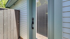 A wooden gate, a door with a keypad lock, and a window with a screen. - Walk to Zilker Park, Barton Springs Pool! Cozy Gem (Austin)
