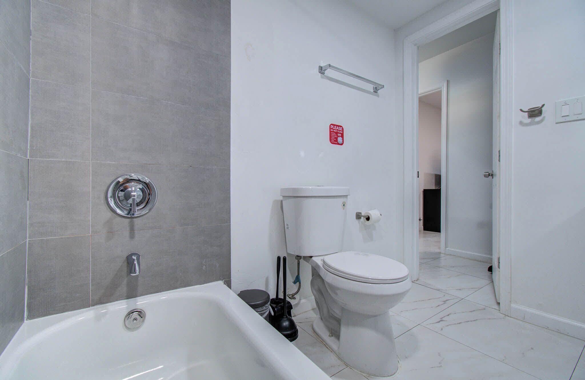 A bathroom with a bathtub, toilet, and sink.