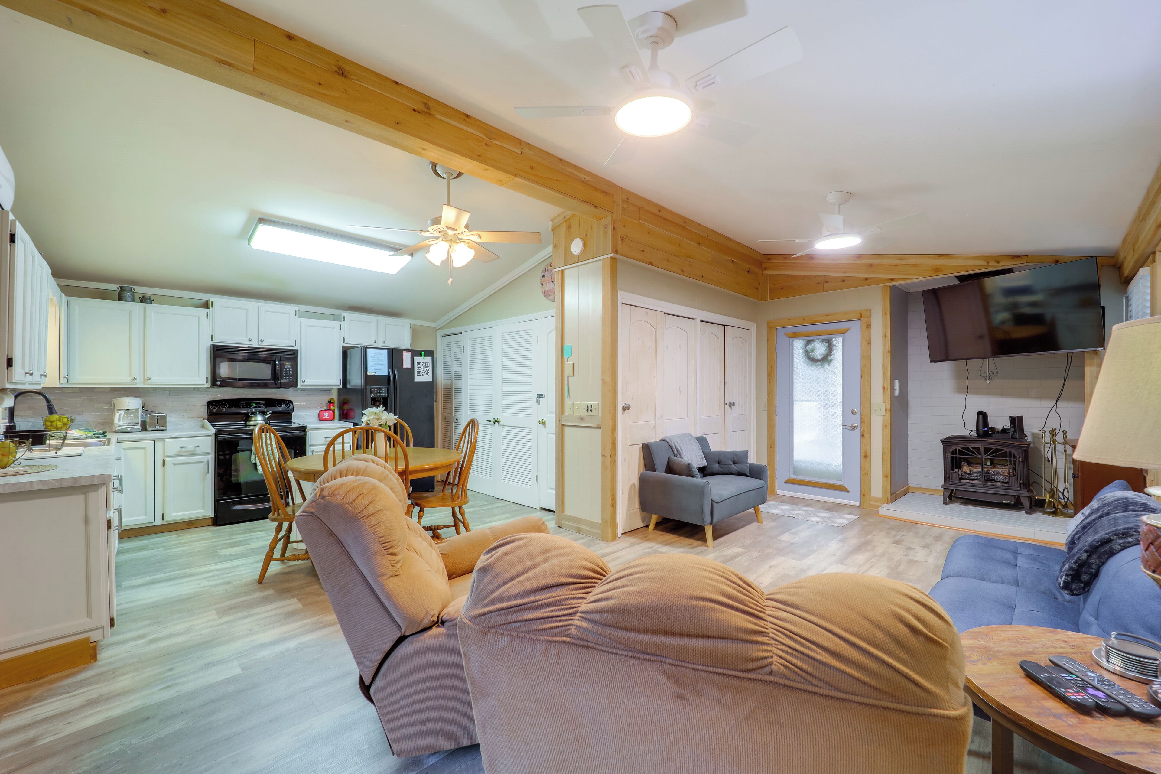 A spacious living area with a sofa, a dining table, and a TV.
