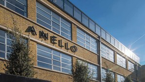A modern building with the sign "ANELL" on its facade, featuring large windows and a brick exterior. - Stunning Camden Town Balcony Apartment (Greater London)