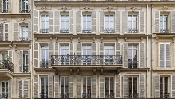 A multi-story building with uniform architectural style, featuring balconies with wrought iron railings and shutters. - Altido Delightful 1bed Studio w Shared Co-working Space (Paris)