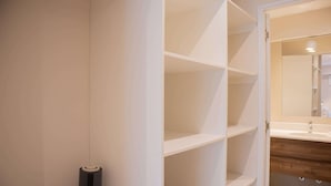 A bathroom with a white vanity, a mirror, and a white shelving unit. - w Bright 3BR w Balcony in Vibrant Miraflores (Lima)