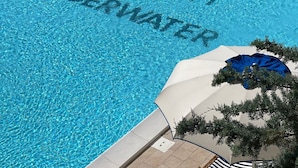 A swimming pool with the words "SORRY NO WIFI UNDERWATER" written on the surface. - Hotel Murè (Numana)