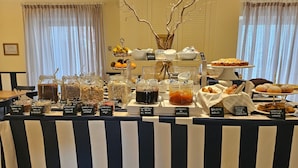 A buffet table with various food items and labels. - Hotel Murè (Numana)