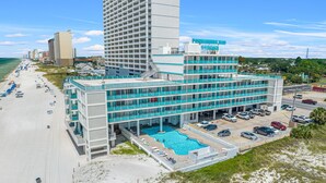 A hotel with a pool, beach access, and a parking lot. - Mermaid Oasis | Updated 4th-Floor Studio w/ Pool & Gulf Views (Panama City Beach)