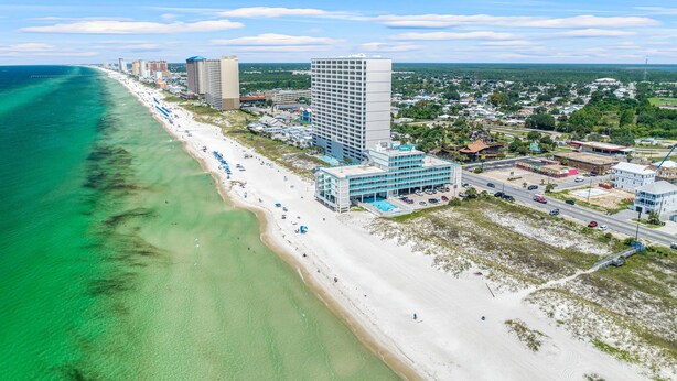 A coastal cityscape with a beach, high-rise buildings, and a clear sky. - Mermaid Oasis | Updated 4th-Floor Studio w/ Pool & Gulf Views (Panama City Beach)
