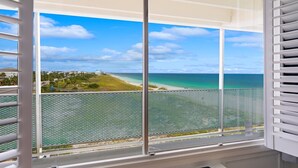 A balcony with a view of a beach and ocean. - Mermaid Oasis | Updated 4th-Floor Studio w/ Pool & Gulf Views (Panama City Beach)