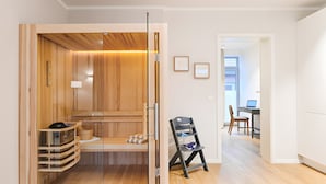 A modern interior with a wooden cabinet, a bench, and a desk with a chair.
