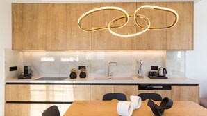 A modern kitchen with wooden cabinets, a stainless steel sink, and a built-in dishwasher. - Villa Santa Irini 3 - With Heated Pool (Rethymno)