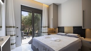 A modern bedroom with a large bed, a desk, and a sliding glass door leading to a balcony. - Villa Me - With Private Pool (Mylopotamos)