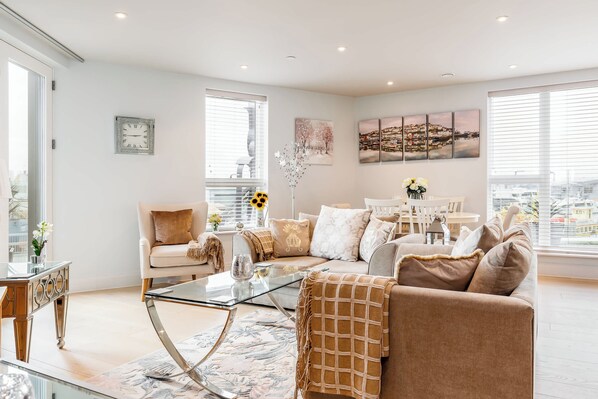 A modern living room with a sofa, coffee table, and decorative items.