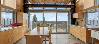 Award-winning 9-level Chameleon House in Leelanau County. A modern-industrial masterpiece with reflective siding, rooftop deck, and epic Lake Michigan views near beaches and Fishtown.