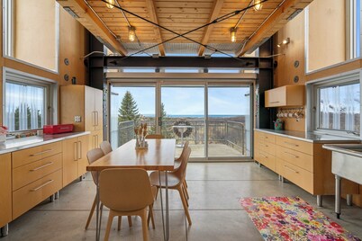 Award-winning 9-level Chameleon House in Leelanau County. A modern-industrial masterpiece with reflective siding, rooftop deck, and epic Lake Michigan views near beaches and Fishtown.