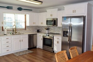 Fridge, microwave, oven, stovetop - Beautiful Holden Beach Canal front home with dock! (Holden Beach)