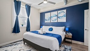 A bedroom with a bed, a nightstand, a ceiling fan, and artwork on the wall. - Bright & Upscale|King Bed|Free Parking w/Workspace (Pittsburgh)