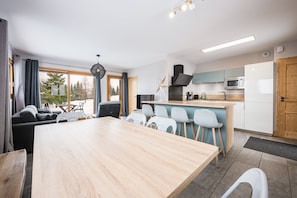 A modern kitchen with a microwave, stove, and wooden cabinets.