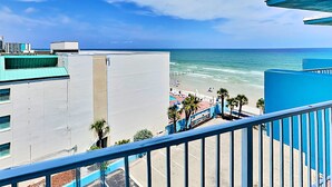 A balcony with a view of a beach and ocean. - The Salty Fountain by Distinctive Beach Rentals (Daytona Beach)