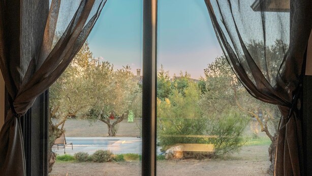 A view through a window with sheer curtains, revealing a landscape with trees, a bench, and a path. - Guest Room "Room 2" with Mountain View, Shared Pool and Wi-Fi (Aléria)