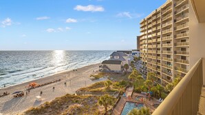 A beachfront hotel with a pool, beach access, and a view of the ocean. - 702 | Cozy Fall Beachfront Retreat—1BR, Gulf Views, Pool & VIP Beach Service (Panama City Beach)