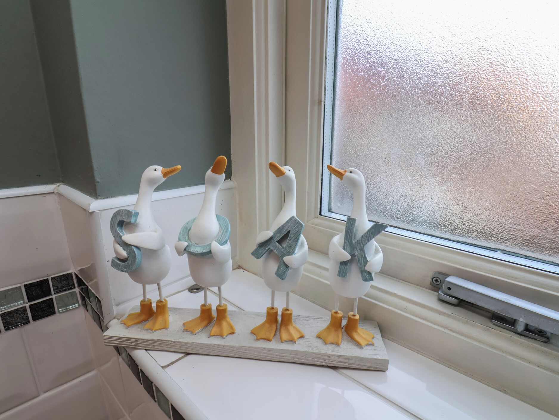A kitchen counter with a decorative duck figurine arrangement.