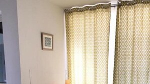 A living room with a sofa, a cabinet, and curtains. - 1BR Alloggio Apartment (Isca sullo Ionio)