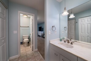 A bathroom with a white sink, two overhead lights, and a large mirror. - Waterfront 1BR 2BA Condo. Marina Views! Pet Friendly-2 dogs Lake House access only (Seabrook Island)