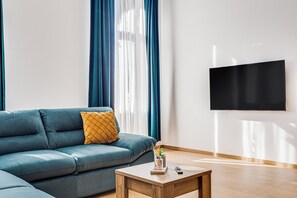Apartament, 1 llit de matrimoni i sofà llit, balcó | Sala d'estar | Televisor de pantalla plana de 40 cm amb canals per cable