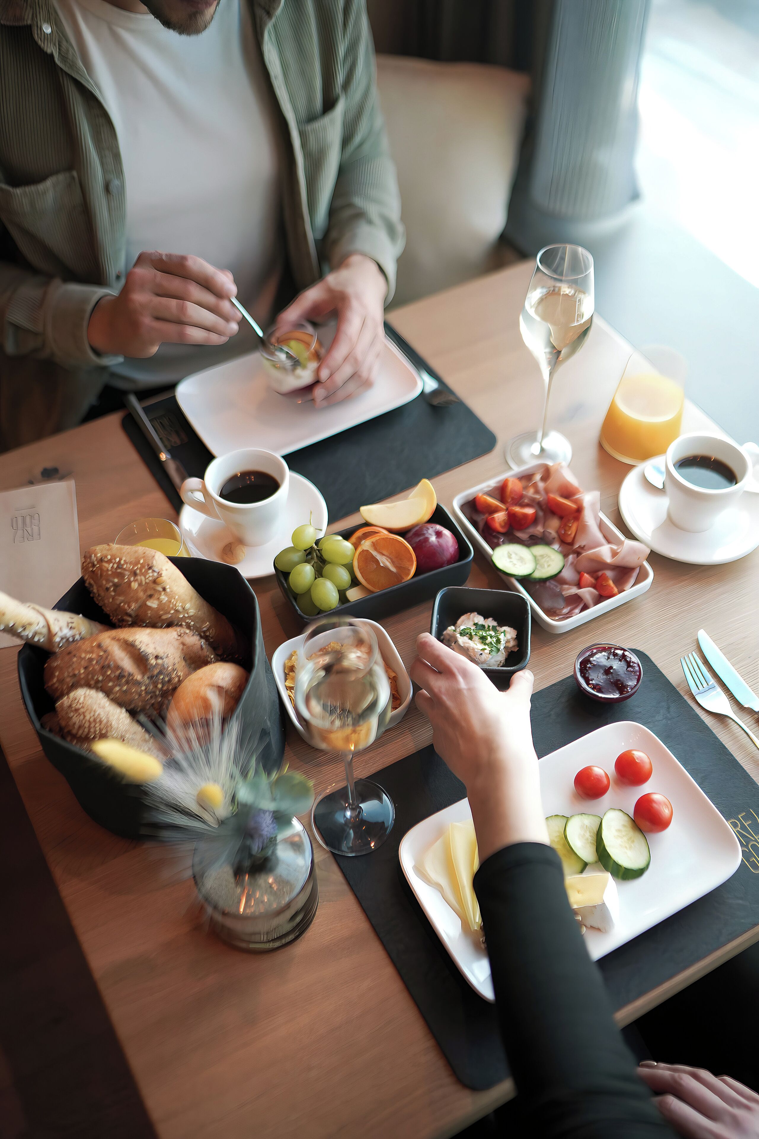 A breakfast setting with a variety of food items and drinks on a table.