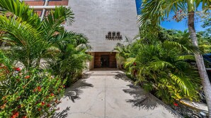 A building with a concrete facade and a sign that reads "PHILADELPHIA." - Spacious 2BR Condo with Pool & Private Balcony (Tulum)