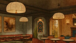 A cozy cafe with green sofas, wooden tables, and hanging lamps. - Hotel Daphne (Houston)
