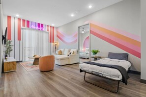 A modern bedroom with a bed, a sofa, a chair, a small table, and a mirror. - Nashville Gem near Honky-Tonks! (Nashville)
