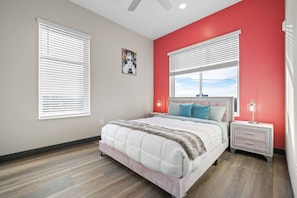 A bedroom with a bed, two bedside tables, a window with blinds, and a ceiling fan. - Perfect for Family Getaway - Mins from Music City! (Nashville)