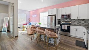 A modern kitchen with white cabinets, a stainless steel refrigerator, and a black stove. - Perfect for Family Getaway - Mins from Music City! (Nashville)