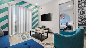 A modern living room with a sofa, a coffee table, and a TV. - Cozy 1BR Escape – Close to the Heart of Nashville! (Nashville)