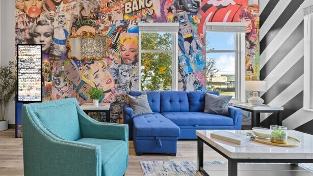 A living room with a blue sofa, teal armchair, and a coffee table.