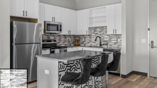 A modern kitchen with white cabinets, a stainless steel refrigerator, a microwave, and a patterned backsplash. - Trendy Oasis: 8 Min to Broadway, Sleeps 4! (Nashville)
