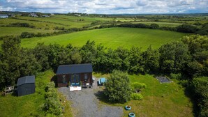 A rural property with a house, a small shed, and a fenced pasture. - Cute cosy and chilled cabin in lahinch (Lahinch)