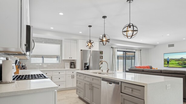 A modern kitchen with a central island, stainless steel appliances, and pendant lighting. - Scottsdale Sunstone Villa, Modern 6BR w/ Private Pool & Spa, Walk to Old Town (Scottsdale)