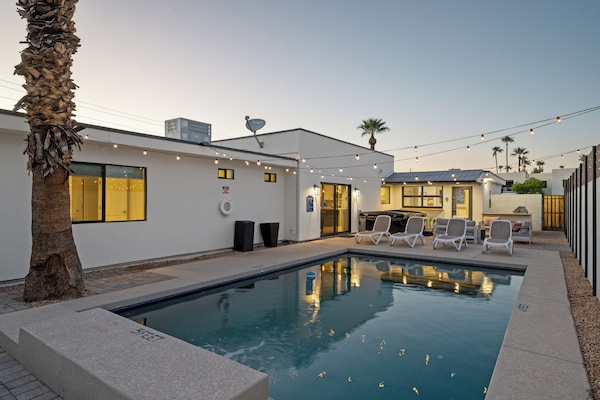 Relax in your own sparkling pool under palm trees