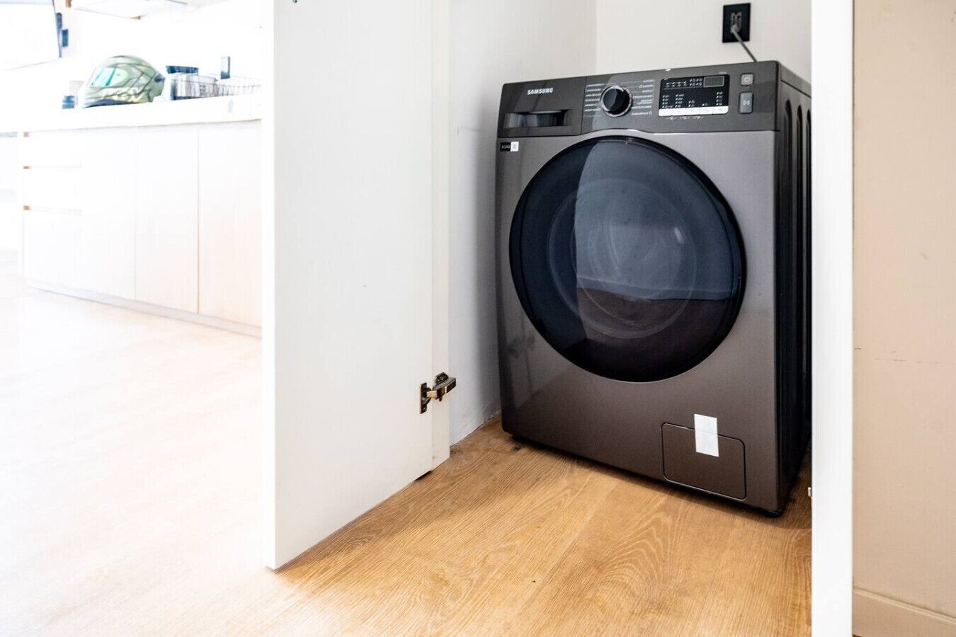Un lave-linge compact et moderne, installé dans un logement résidentiel.