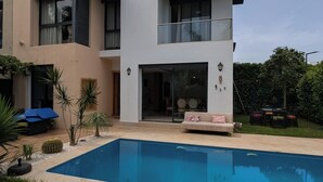 A modern two-story house with a swimming pool, outdoor furniture, and a well-maintained garden. - Lovely 3-bedroom villa with Private  Pool in Tamaris (Tamaris)