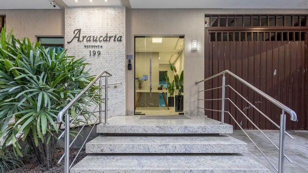 A hotel entrance with a name sign, a staircase, and a metal railing. - Apt w/ Balcony & BBQ 290m From the sea Cau0199 (Itapema)