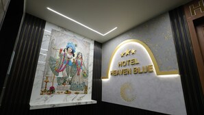 A hotel sign with a decorative mural and a modern interior design. - Hotel Heaven Blue (Rajkot)