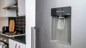 A stainless steel water dispenser with a clear water bottle. - Modern 3 bed perfect for contractors and families (Maltby)